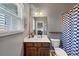 Cozy bathroom featuring vanity, commode, and shower, and natural light from the window at 1222 Poston Se Pl, Smyrna, GA 30080