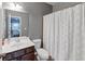 Bright bathroom featuring a vanity, toilet, and a shower with a patterned shower curtain at 1222 Poston Se Pl, Smyrna, GA 30080