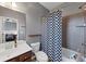 Cozy bathroom featuring vanity, commode, and shower, and a checkered shower curtain at 1222 Poston Se Pl, Smyrna, GA 30080
