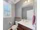 Cozy bathroom features a single sink vanity, toilet, and window, providing natural light and essential functionality at 1222 Poston Se Pl, Smyrna, GA 30080