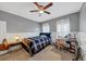 Cozy bedroom with a ceiling fan, wainscotting, and bright natural light from the windows at 1222 Poston Se Pl, Smyrna, GA 30080