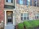 Close-up of the stone exterior, front door and small landscaped area at 1222 Poston Se Pl, Smyrna, GA 30080