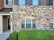Close-up of the stone exterior, front door and small landscaped area at 1222 Poston Se Pl, Smyrna, GA 30080