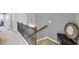 Upstairs hallway with carpet, wooden railing, and decorative wall mirror at 1222 Poston Se Pl, Smyrna, GA 30080