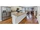 Modern kitchen featuring a large island, stainless steel appliances, granite counters and hardwood floors at 1222 Poston Se Pl, Smyrna, GA 30080