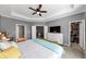 This main bedroom includes a closet, a ceiling fan, and a mounted TV at 1222 Poston Se Pl, Smyrna, GA 30080