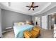 Comfortable carpeted main bedroom featuring a ceiling fan, tray ceiling and walk-in closet at 1222 Poston Se Pl, Smyrna, GA 30080
