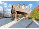Outdoor fireplace and pavilion featuring a charming stone fireplace and ample seating under a stylish gable roof at 1222 Poston Se Pl, Smyrna, GA 30080