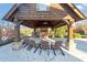 Outdoor pavilion featuring a stone fireplace and wood chairs creating an inviting space for gatherings at 1222 Poston Se Pl, Smyrna, GA 30080