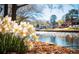 Scenic pond view with daffodils in the foreground, surrounded by beautiful landscaping and community buildings at 1222 Poston Se Pl, Smyrna, GA 30080