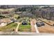 Aerial view of two homes on large lots with swimming pool, garages and mature trees at 1694 Mount Bethel Rd, Mcdonough, GA 30252