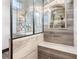The ensuite bathroom showcases custom tilework, a bench seat in the shower, and unique glass partition at 1694 Mount Bethel Rd, Mcdonough, GA 30252