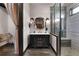 An elegant ensuite bathroom features a dark vanity, custom tilework, a walk-in shower, and accent lighting at 1694 Mount Bethel Rd, Mcdonough, GA 30252