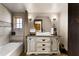 Bathroom featuring a rustic vanity with granite counters and a round mirror at 1694 Mount Bethel Rd, Mcdonough, GA 30252