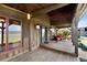 Spacious covered porch with comfortable seating, wood decking, and stylish outdoor lighting at 1694 Mount Bethel Rd, Mcdonough, GA 30252