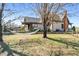 Exterior view of home, with a hammock strung between trees in the yard at 1694 Mount Bethel Rd, Mcdonough, GA 30252