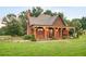 Charming home featuring a covered porch with timber beams, shingle siding, and mature landscaping at 1694 Mount Bethel Rd, Mcdonough, GA 30252
