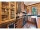 Kitchen featuring brick accent wall, custom cabinetry, granite countertops, and modern appliances at 1694 Mount Bethel Rd, Mcdonough, GA 30252