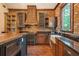 Rustic kitchen featuring brick walls, custom cabinetry and stainless-steel appliances at 1694 Mount Bethel Rd, Mcdonough, GA 30252