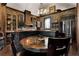 Rustic kitchen with brick walls, custom wood cabinets, stainless steel appliances, and a round dining table with chairs at 1694 Mount Bethel Rd, Mcdonough, GA 30252