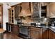 Kitchen with brick backsplash, custom cabinetry, wine cooler, and stainless steel appliances at 1694 Mount Bethel Rd, Mcdonough, GA 30252