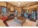 Living room with fireplace, hardwood floors, and seamless connection to the brick kitchen at 1694 Mount Bethel Rd, Mcdonough, GA 30252