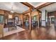 Open-concept living space featuring hardwood floors, exposed timber beams, and a cozy fireplace at 1694 Mount Bethel Rd, Mcdonough, GA 30252