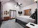 Spacious main bedroom with a high vaulted ceiling, ceiling fan, dark wood trim, and natural light at 1694 Mount Bethel Rd, Mcdonough, GA 30252