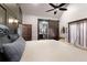 A well-lit main bedroom includes a barn door to the ensuite, seating, and a ceiling fan at 1694 Mount Bethel Rd, Mcdonough, GA 30252