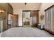 A sprawling main bedroom features neutral carpet, bench seat, an ensuite, barn door, and plenty of natural light at 1694 Mount Bethel Rd, Mcdonough, GA 30252