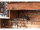 Kitchen features a unique pot filler against a brick wall, and custom wood cabinetry at 1694 Mount Bethel Rd, Mcdonough, GA 30252