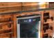 Stylish wine fridge nestled in custom wood cabinetry, perfect for wine enthusiasts at 1694 Mount Bethel Rd, Mcdonough, GA 30252