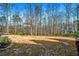 Lush backyard with a fire pit area and view of the house nestled among the trees at 268 Hanson Way, Marietta, GA 30064