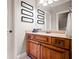 Bathroom featuring wood cabinets, a granite countertop, framed wall art and a large mirror at 268 Hanson Way, Marietta, GA 30064