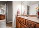 Bathroom featuring wood cabinets, tile floor, granite countertops, and a large mirror at 268 Hanson Way, Marietta, GA 30064