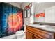 Bathroom featuring a basketball-themed shower curtain and a granite countertop vanity sink at 268 Hanson Way, Marietta, GA 30064