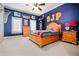 Comfortable bedroom featuring carpet, blue walls, basketball decor, and window with white trim at 268 Hanson Way, Marietta, GA 30064