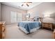 Cozy bedroom with a blue quilt on the bed, bedside tables and shutters on the window at 268 Hanson Way, Marietta, GA 30064