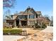 Stunning two-story home with stone accents, manicured landscaping and a driveway leading to an attached garage at 268 Hanson Way, Marietta, GA 30064