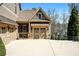Attached three-car garage featuring stone accents and carriage-style doors, on a wide concrete driveway at 268 Hanson Way, Marietta, GA 30064