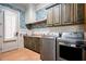 Well-equipped laundry room with cabinetry, modern appliances, and stylish wallpaper at 268 Hanson Way, Marietta, GA 30064