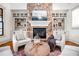 Bright living room featuring a stone fireplace, built-in shelves, and neutral decor at 268 Hanson Way, Marietta, GA 30064