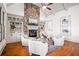 Inviting living room with stone fireplace, built-in shelving, hardwood floors and comfortable seating at 268 Hanson Way, Marietta, GA 30064