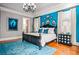Bright main bedroom boasts a tray ceiling, large windows, a blue accent wall, and wood floors at 268 Hanson Way, Marietta, GA 30064
