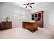 A bright office space with wooden furniture, a ceiling fan, and a large window for natural light at 268 Hanson Way, Marietta, GA 30064