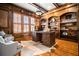Sophisticated home office with wood paneled walls, custom built-ins, and ample natural light from plantation shutters at 268 Hanson Way, Marietta, GA 30064