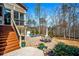 Back patio with outdoor dining and lounging area, set among landscaped gardens and stairs to upper deck at 268 Hanson Way, Marietta, GA 30064