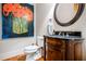 Stylish powder room showcasing dark wood vanity, granite countertop, decorative mirror, and attractive wall art at 268 Hanson Way, Marietta, GA 30064