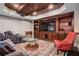 Basement sitting room featuring elegant furniture, a brick ceiling, and a custom cabinet for media at 268 Hanson Way, Marietta, GA 30064