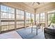Bright sunroom with large windows, wicker furniture, ceiling fan, and wood flooring at 268 Hanson Way, Marietta, GA 30064